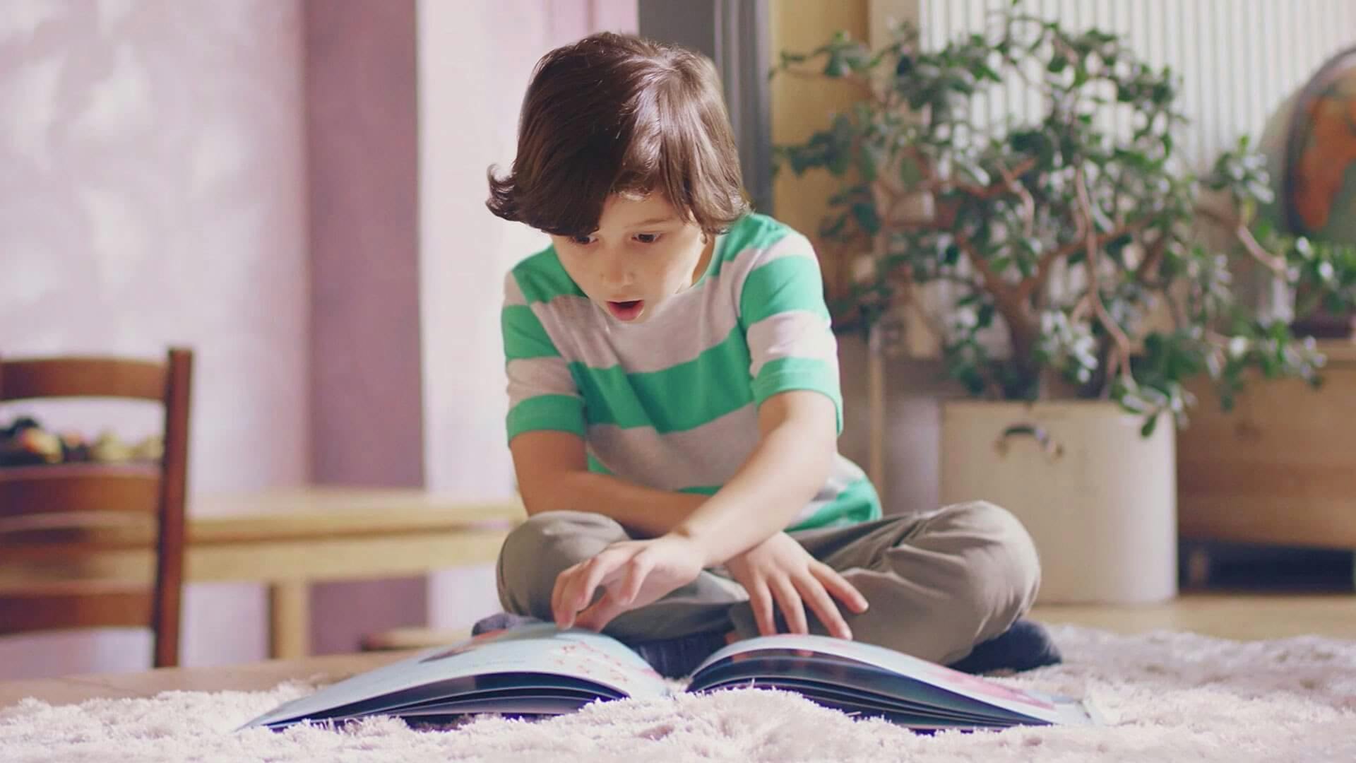 Boy reading a Lost My Name book