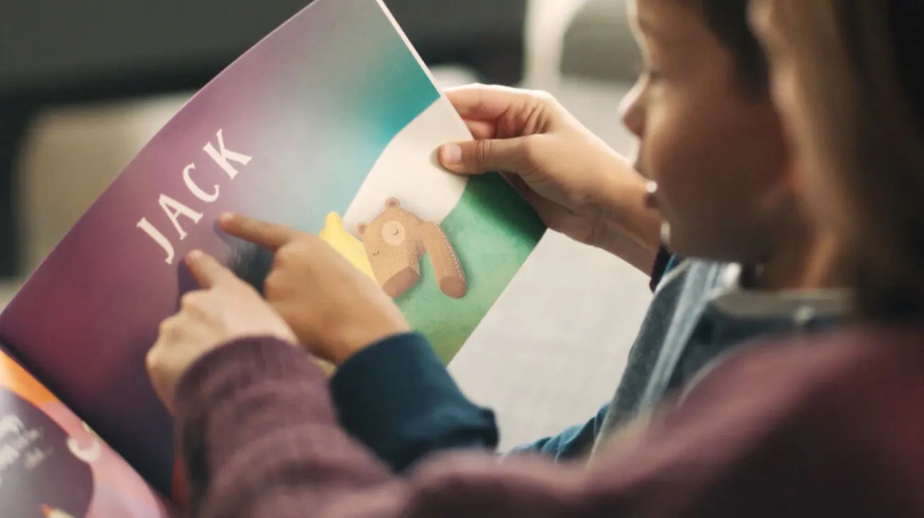 Mother and child reading the book, lost my name, together